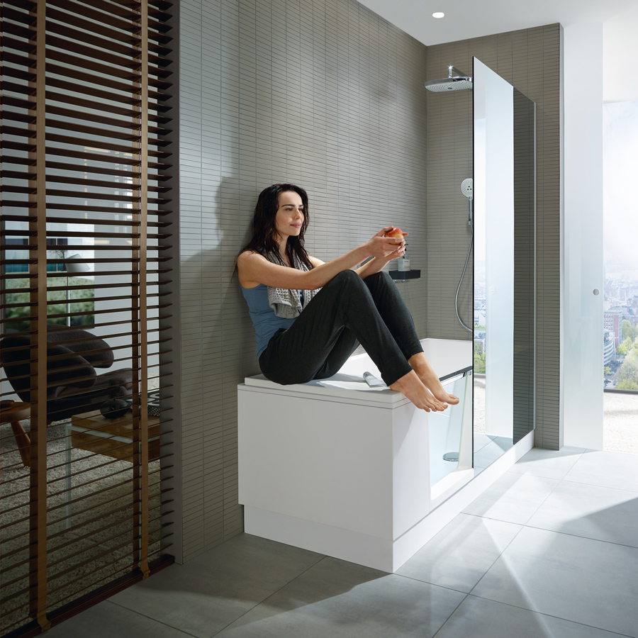 Woman sitting on bench of walk in bathtub
