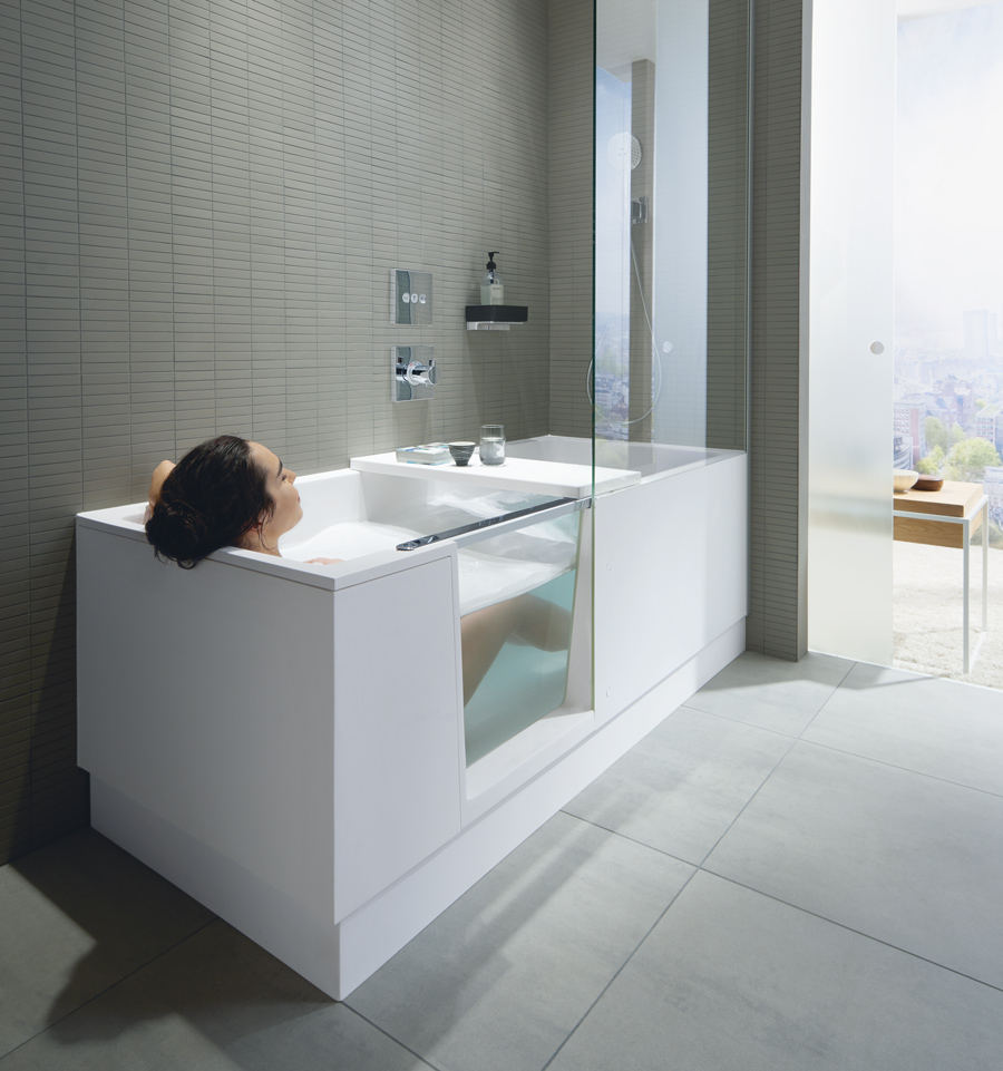 Woman in bathtub with door and shower
