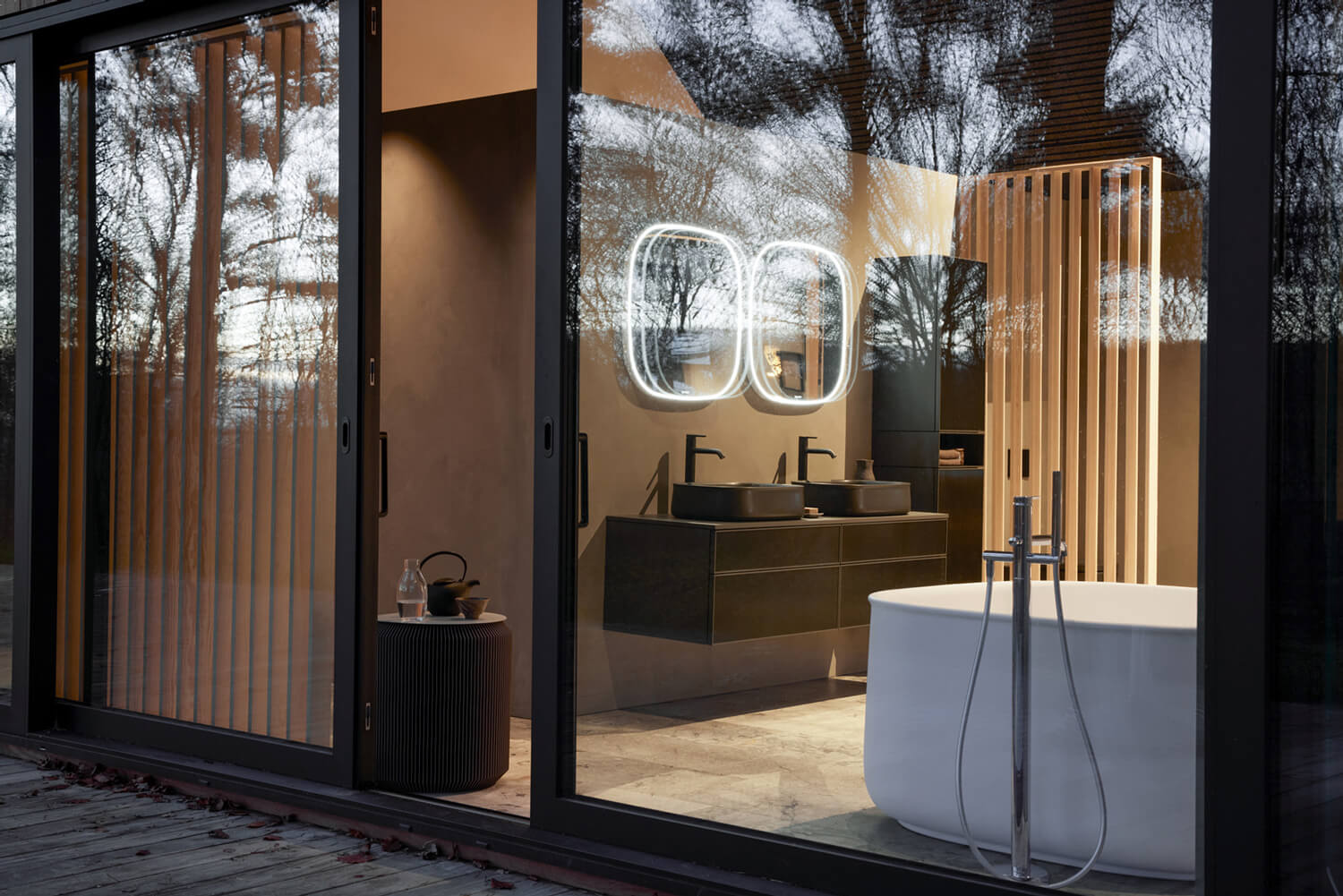 View through glass door into bathroom with Zencha furniture
