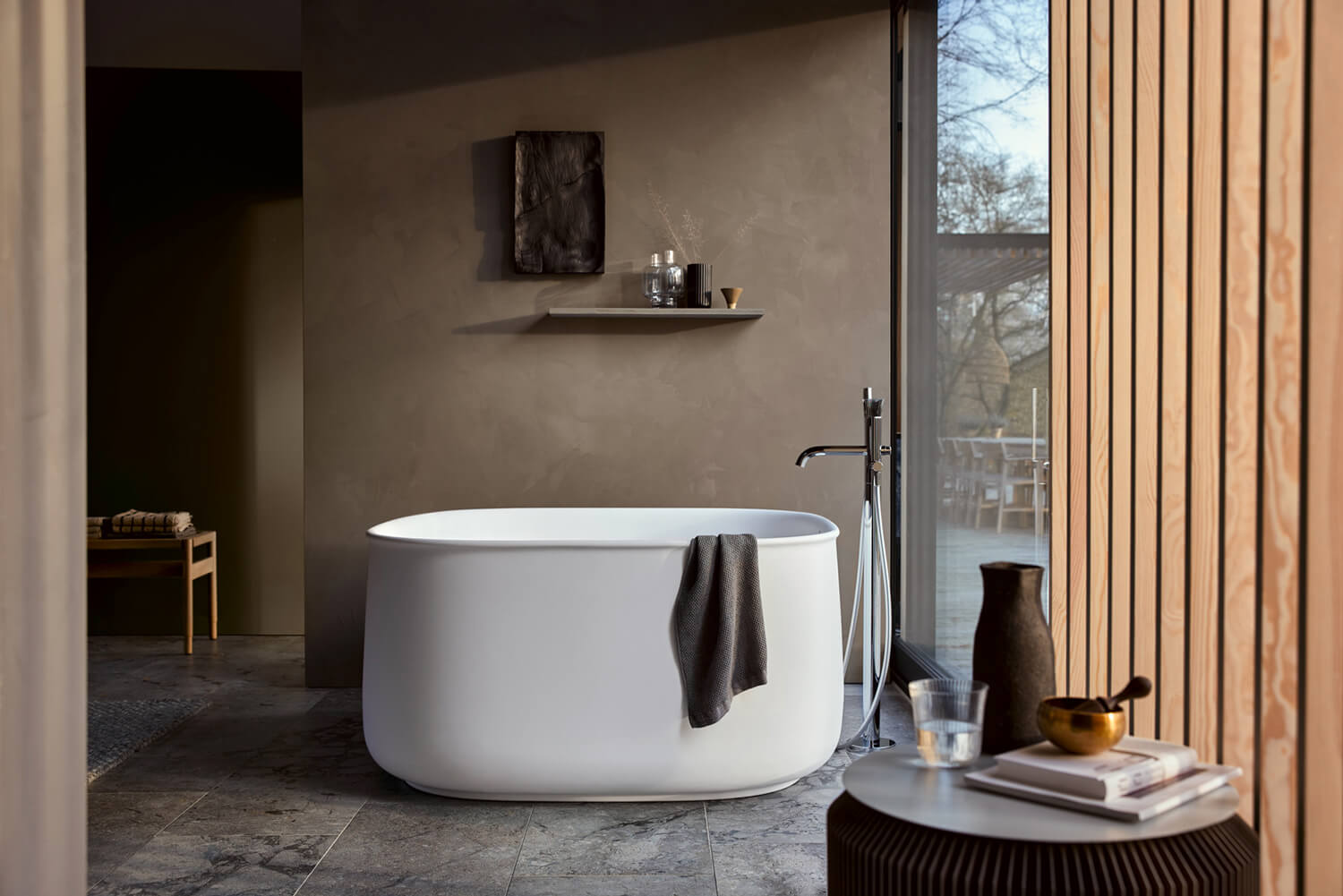 Dark bathroom with freestanding Zencha bathtub
