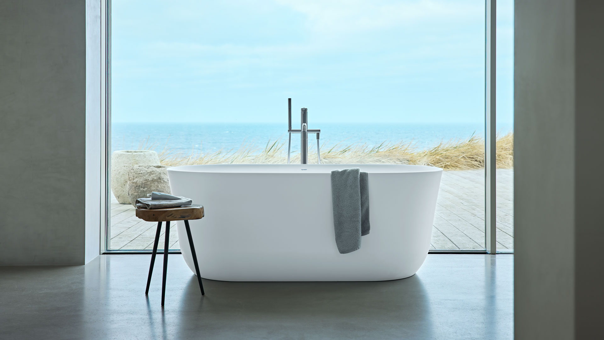 Freestanding Soleil bathtub in front of window
