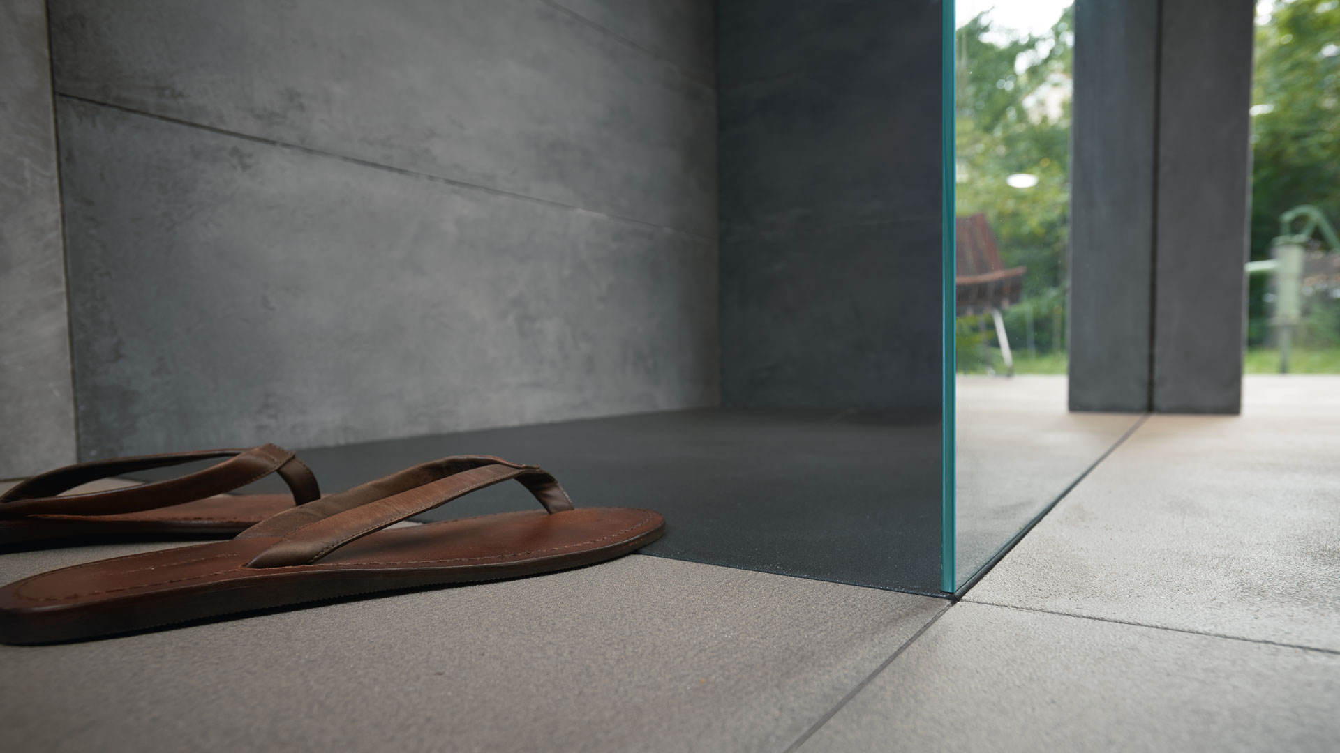 Shoes infront of a walk-in Stonetto shower
