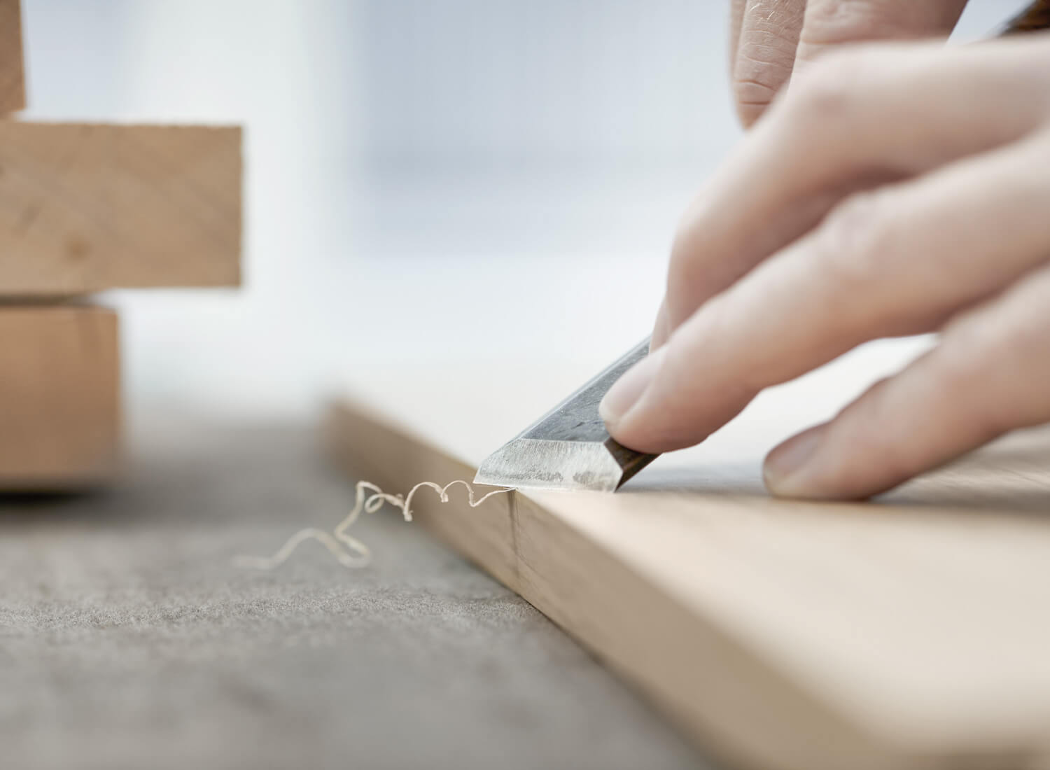 Hand sharpens wooden panel

