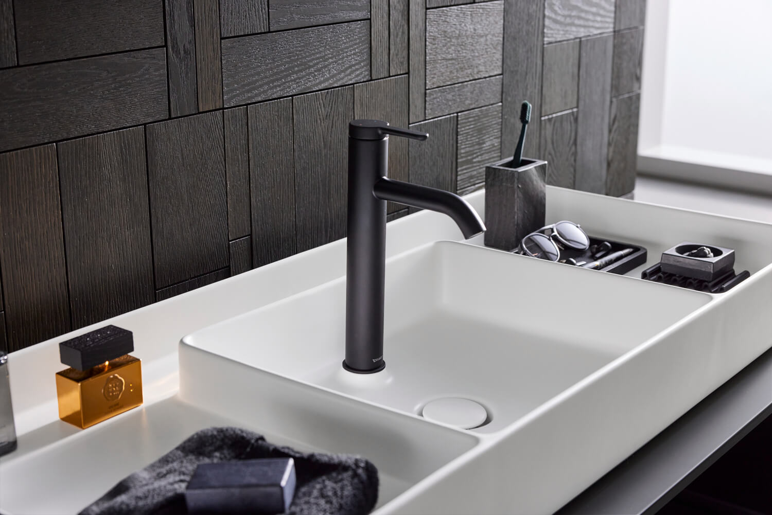 Bento Starck Box countertop sink with dark faucet
